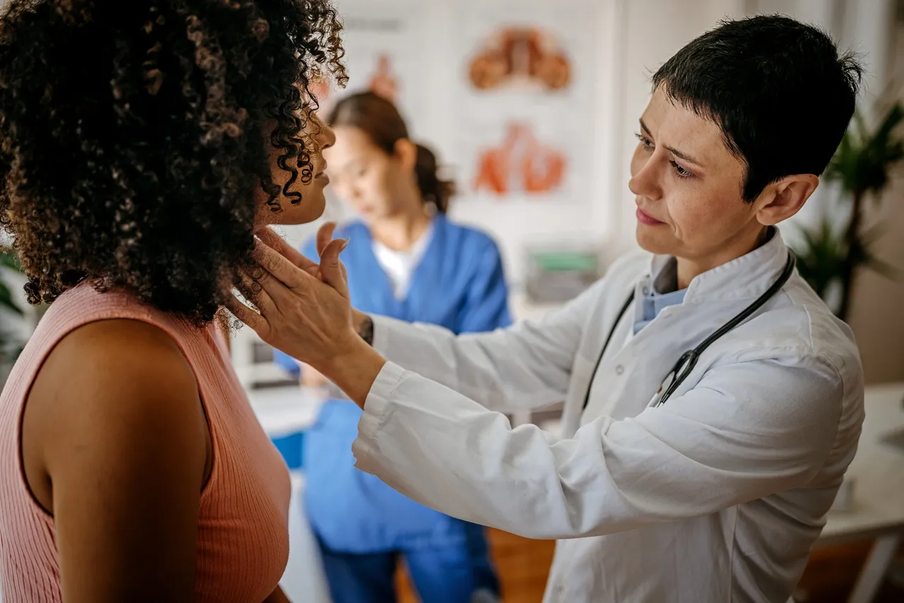 Doctor examining patient's throat in a clinic.